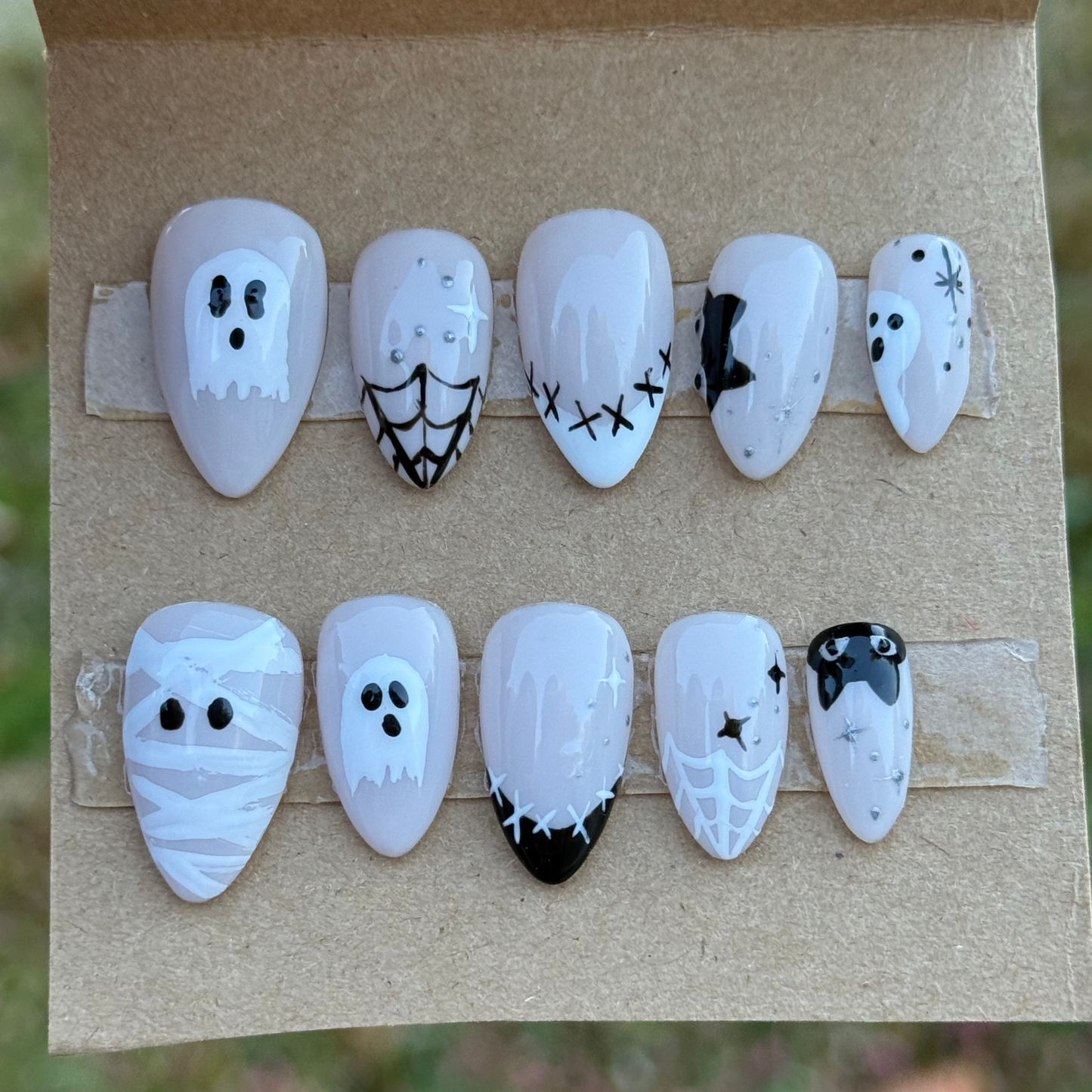 Set of Halloween-themed nail art designs on a cardboard backing.