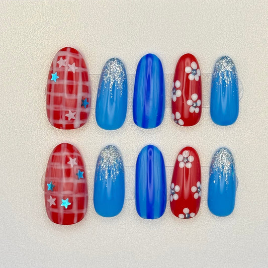 Set of red and blue nail art designs on a white card with a black background